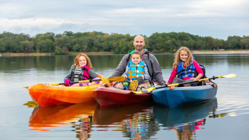 family kayaking on the lake
