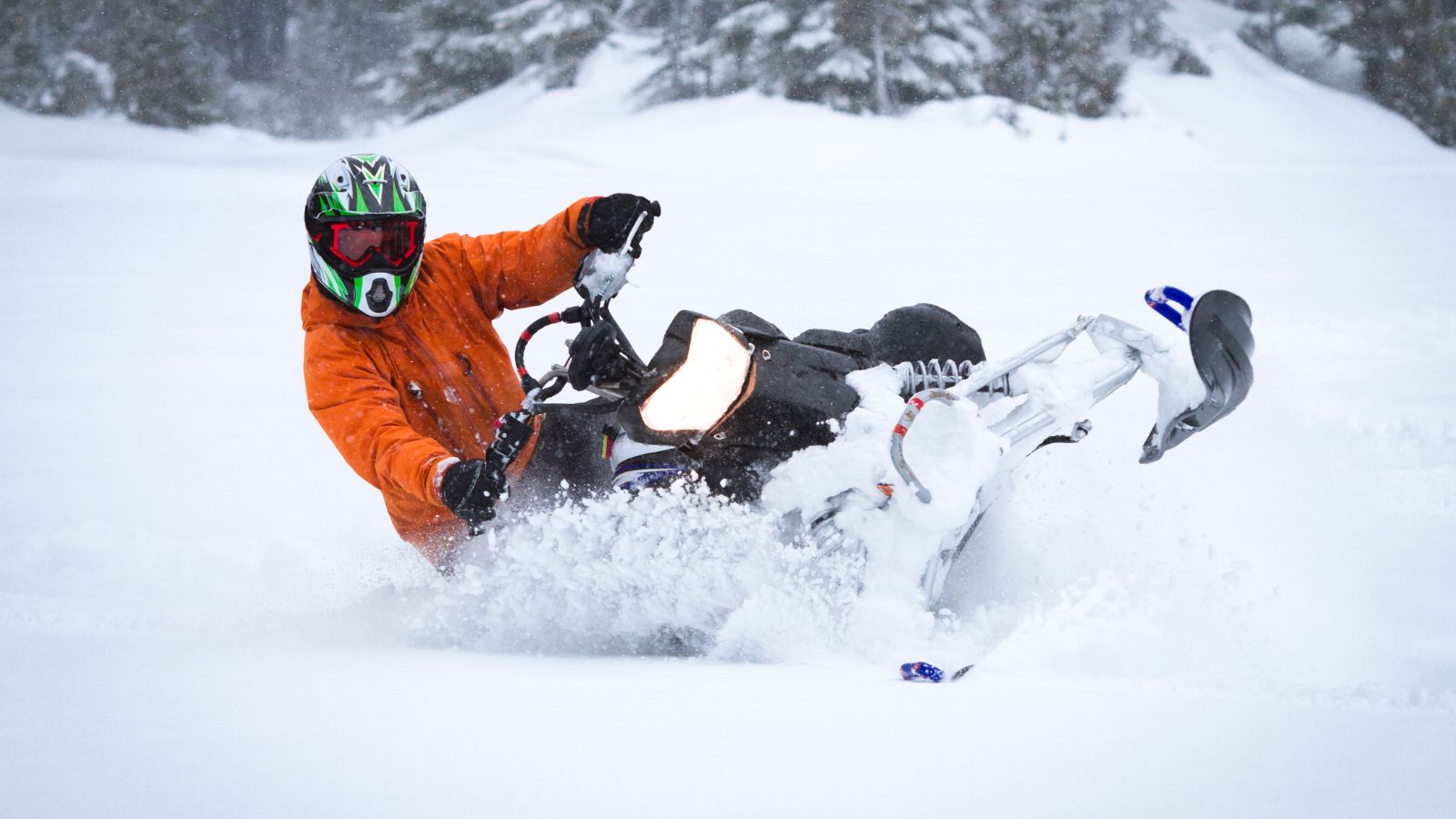a person on a snowmobile driving on snow